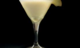 A Key Lime Martini is poured into a glass. 
