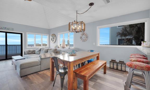 Living room and dining area at a Five Star Vacation Rentals luxury home