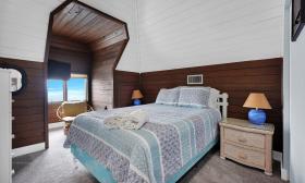 Five Star Vacation Rentals — Bedroom with viewing cutout. 