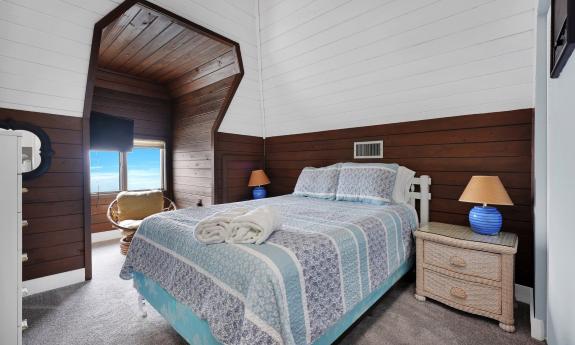 Five Star Vacation Rentals — Bedroom with viewing cutout. 