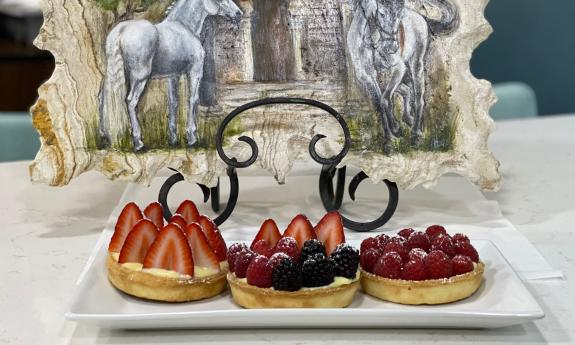 Strawberry tart is positioned in a square dish.