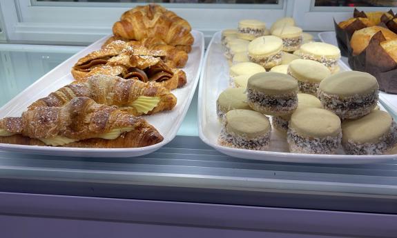 Baked cakes and croissants are placed on display. 