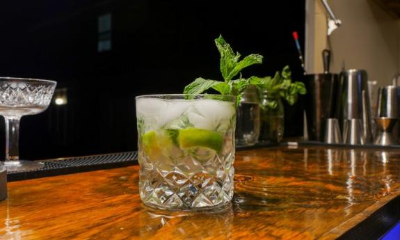 A Red Sky Mojito is placed on top of a bar. 