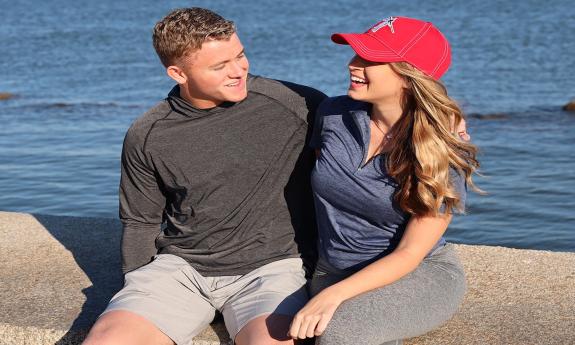 a couple in golf wear by the bay