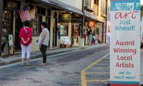 Art lovers browse the galleries on Aviles Street at the Friday Night Art Walk in St. Augustine, FL