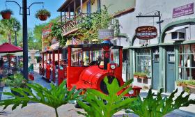 Ripley's Red Train seen over foliage as it moves down Aviles Street in St. Augustine