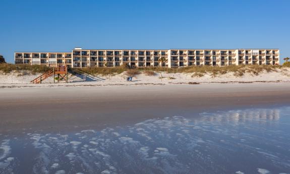 Beacher's Lodge as seen from the ocean on a blue-sky day