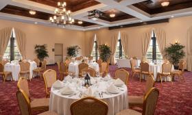 The banquet room at DoubleTree by Hilton, in St. Augustine, set with round tables and 8 place settings