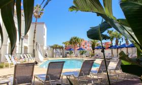 Guests can relax on lounge chairs around the tropical pool at the Hampton Inn and Suites in Vilano Beach