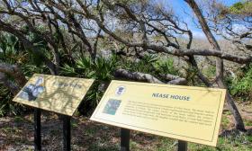 Informational signs highlighting the original owner of the site of Nease Beachfront Park