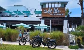 Two e-bikes, parked in front of Salt Life in St. Augustine Beach
