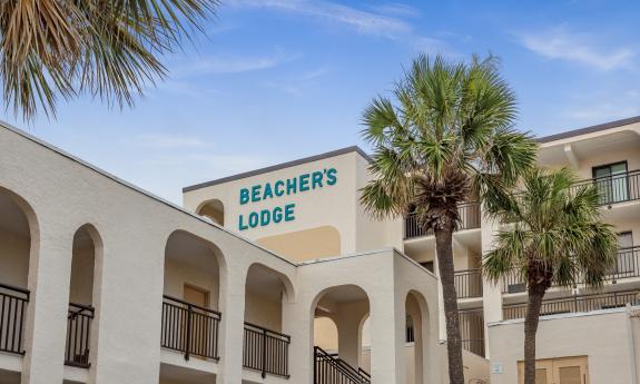 A view of the roofline and sign at Beacher's Lodge on a sunny day