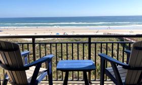 A view of the beach from the patio of a rental at Beacher's Lodge
