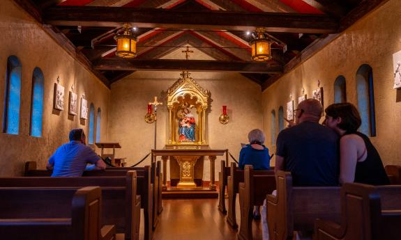 The shrine at Nombre de Dios, with guests spending a quiet moment in the pews