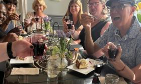 Guests on a food and wine tour toast the chef at one of the stops