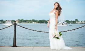Bride posing by the water in Historic Downtown