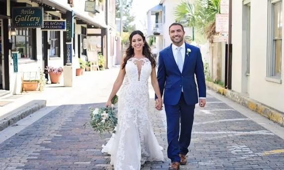 Bride and groom walking down Aviles Street