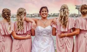 Bride and bridesmaids showing off hairstyles at sunset