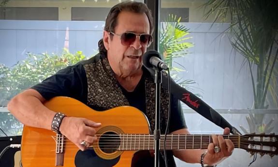 Luis Mario Peral playing Latin jazz on an acoustic-electric guitar
