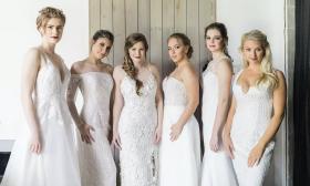 Brides with an array of makeup and hair styles posing together