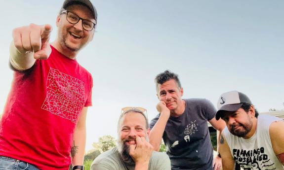 The punk rock band Small Disasters; four men smiling at the camera