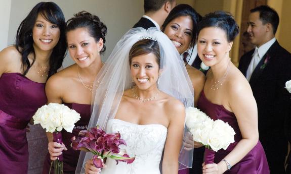 Bridesmaids posing with bride in lobby