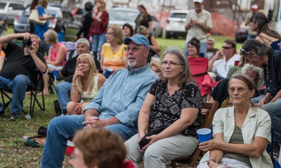 The audience at the St. Benedict the Moor Blues Fest, sitting in lawn chairs at the outdoor event