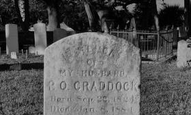 A black and white graveyard marker