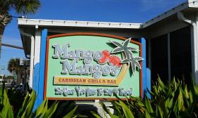 A sign advertising Mango Mango's Caribbean Bar & Grill