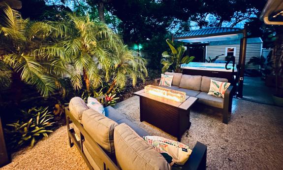 The back yard at Casa Paraiso features a seating area and large hot tub with night lighting