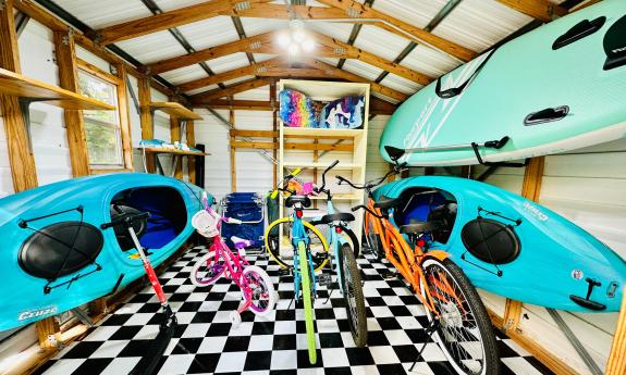 Brightly colored bikes kayaks, and a SUP, are ready in the outdoor storage area at Paraiso in Vilano