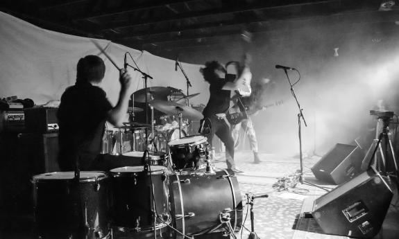 Tongues of Fire, with the drummer in the forefront, on stage during a show