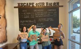 Group at Axscape poses for photo after their escape room challenge