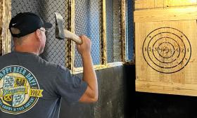 Man takes aim at an axe-throwing target