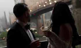 Bride and groom share a moment in NYC, drinks in hand