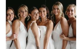 Women in white gowns posing together