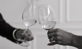 Bride and groom toasting wine glasses