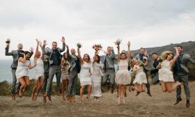 Bridal party jumping into the air for a posed motion photo