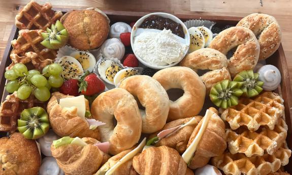 A Floating Food Company box featuring bagels, waffles, fruits and cheeses