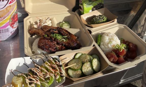 Ribs, pepper skewers, sliced cucumbers and a poké bowl