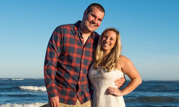 A couple's engagement photo in front of the ocean