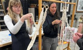 Artists and students crafting artistic rope braids
