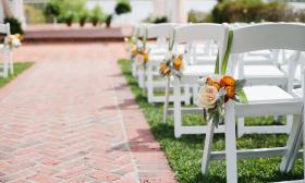 Chairs lined and decorated for an outdoor wedding
