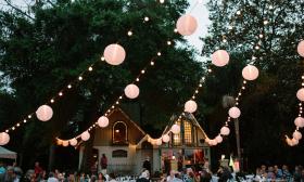 Outdoor lighting and wedding decor over reception area