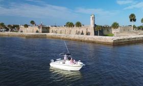Todd's Rods Fishing Charters' boat passing the Castillo de San Marcos