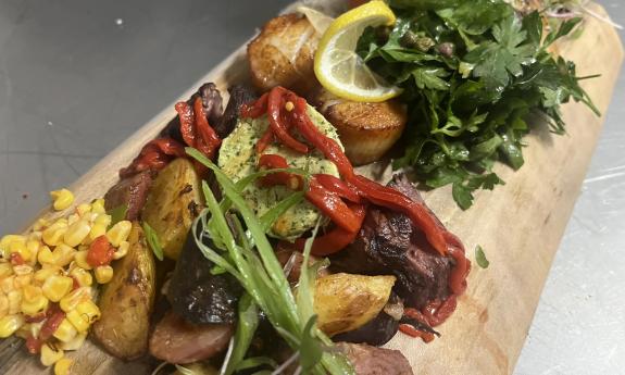 Various foods assembled with garnishes on a serving board