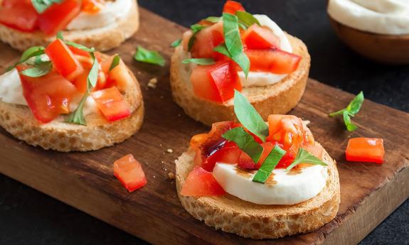 A bruschetta dish that is garnished and ready to be served