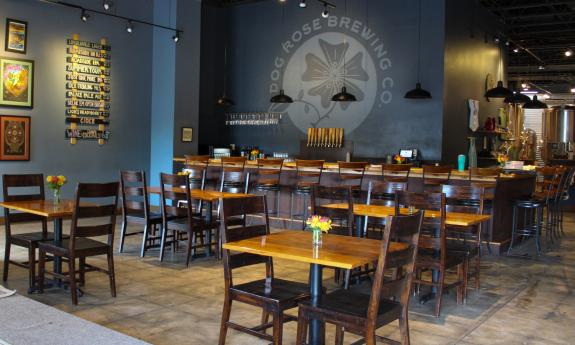 The interior of Dog Rose Brewing, wooing the bar and table seating