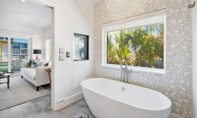 The master bath at this Euphoria Vacation Home has a deep stand-alone tub