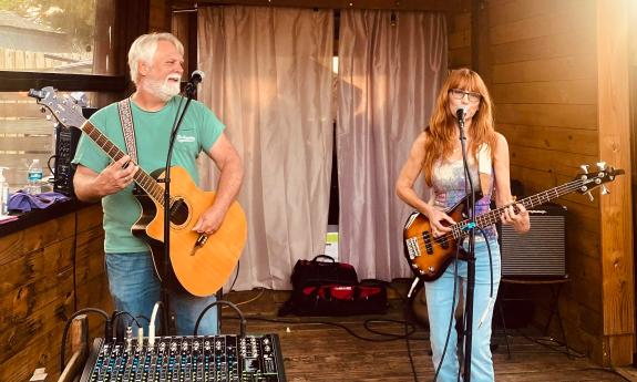 Bryson and Amy of the Flajberries perform on a small outdoor stage at Borillo's